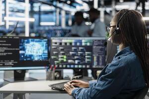 Data center support expert talking in headset microphone, supporting engineering team doing equipment maintenance. Employee in server farm coordinating technicians using mic photo