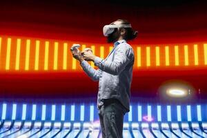 Modern man in a neon lit night scene using vr high tech glasses, embodying cyberpunk style and digital inspiration through artistic vision. Glowing reflections of futuristic aesthetics. photo