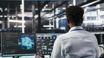 Server hub programmer using AI machine learning node tree software to optimize system health. Data center IT expert analyzing equipment issues using artificial intelligence visualization, camera B photo