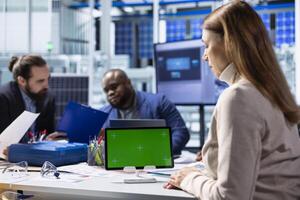 Solar panels plant specialists using isolated screen tablet to study energy systems, developing technologies. Photovoltaics factory researchers work on mockup device to improve efficiency, close up photo