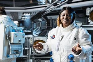 Portrait of cheerful female astronaut in futuristic spacecraft navigating orbital trajectory. Jolly woman in spaceship conducting safety checks during planetary exploration photo