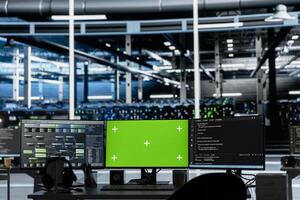 Mockup computers in data center facility used for managing supercomputers hardware energy consumption. Green screen PCs used for automation and monitoring processes in server farm photo