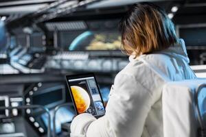 Astronaut checks tablet before landing spaceship powered by advanced engineering on Mars. Crew preparing for mission launch to red planet surface, testing future human survival in deep space photo