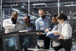 Engineering team working together in data center with artificial intelligence neural networks tech. Server farm staff members cooperating, using AI programming language to update equipment photo