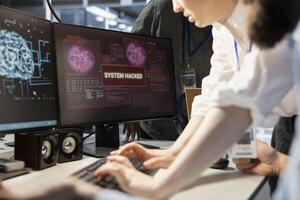 Close up of engineering team reviewing AI systems warnings after detecting irregular network activity patterns. Teamworking colleagues evaluating threats using artificial intelligence detection tools photo
