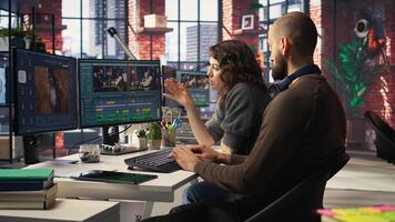 Team of experts editors working in production industry at agency office, doing color grading and creating a montage on dual monitors. Creative process with multimedia tech tools. Camera A. photo