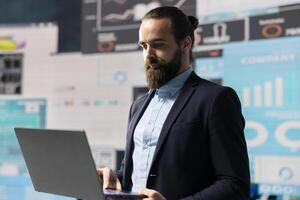 Data driven planning helps this professional to build a successful strategy for global business development. Using charts on dashboard and projections to guide his leadership ideas for growth. photo