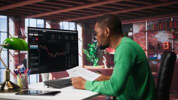 Man using PC to purchase and sell stocks, monitoring forex graphs and diagrams. Male broker looking at stock exchange candle stick charts on computer. Camera B. photo
