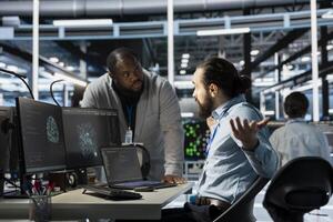 Data center manager berating employee during intense discussion, reproaching performance issues. Technician in server hub receiving verbal reprimand from upset management team leader photo