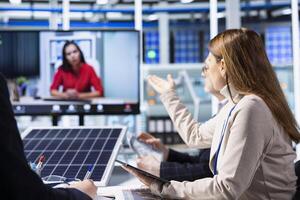 Investors evaluating photovoltaics factory production efficiency during online videocall before investing. Shareholders doing teleconference meeting with managers to ask technical questions photo