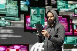 In a dark web illegal setting, hacker typing malicious code to exploit IT security systems and breach firewalls. Operating in stealth mode to expose private data through threat operations. photo