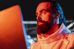 Spaceship engineer using notebook device to fix security breach causing alarm to sound. Space station technician reacts to system failure as hazard detection system triggers emergency lights photo