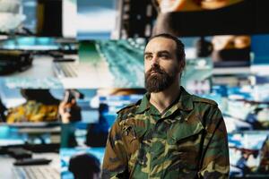 Armed forces officer monitoring drone and satellite imagery to gather intelligence, collecting insight for war planning. Support mission control and secure global operations through cyber defense. photo