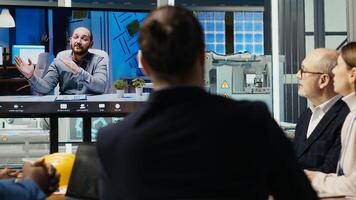 Experts optimize factory equipment energy output during teleconference call. Photovoltaics researchers doing videocall meeting, evaluating energy production, camera B photo