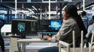 Computer scientist using artificial intelligence deep learning models to configure hardware. IT specialist using AI programming languages on PC in server farm, optimizing system, camera A photo