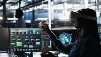 Data center engineer using virtual reality technology and node tree software to analyze datasets. Server room worker using visual programming tools and VR gear to improve gear performance photo