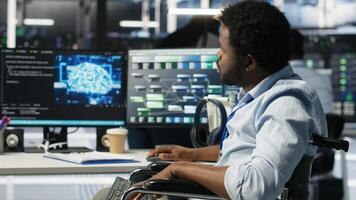 Engineer in wheelchair using AI node tree software to minimize system downtime. Server hub worker in disability using visual programming to monitor performance, camera B photo