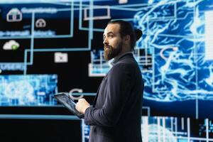 Young entrepreneur works on implementing AI brain system for deep learning, employing neural network and cybernetics for development. Driving smart technology and algorithmic thinking. photo