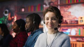 Friendly customer support workers respond to inquiries about products or services. Cheerful call center agent in office providing accurate and satisfactory information to clients, camera A photo