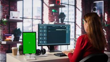 Freelancer interacting with AI virtual assistant next to mockup screen, using innovative chatbot web interface. Machine learning enhances productivity through advanced algorithms. Camera B. photo