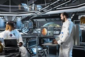 Cosmonaut running data analysis on monitor before Mars expedition, preparing for future of mankind. Astronaut looks at interface showing orbital path, exploring red planet to support human life photo