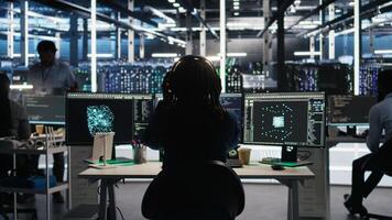 Engineer using algorithms to analyze datasets, putting on headphones. Server farm IT professional listening to music and using artificial intelligence to recognize data patterns, camera A photo