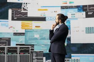 Modern business leader thinking about new successful ideas to increase his company profits, using insight and KPI projections or models to help guide strategic decision making. photo