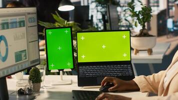 Mockup tablet and laptop in office used by employee working on company administrative tasks. Chroma key devices on desk used by worker reviewing business metrics, camera A photo