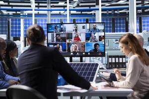 Manager in internet call with buyers trying to secure funding during solar panels materials presentation. Businessman in industrial plant doing remote videoconference to pitch company assets photo