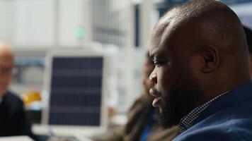 Photovoltaics engineering team works on breakthroughs in durability and performance in office. Teamworking research and development coworkers testing materials for next generation solar panels photo