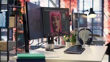 Modern office equipped for digital design and photo editing. Screens show advanced editing software for photographers and designers working on image retouching, contrast adjustments.