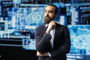 Young businessman studies artificial intelligence neural network on dashboards, using high tech automation tools for coding, analytics and machine learning for strategic development. photo