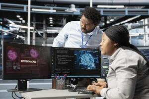 IT staff members in artificial intelligence server hub facility trying to protect servers from hackers. AI data center cybersecurity division colleagues protecting rigs during security breach photo