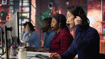 Call center employee listening to client inquiries and complaints. Asian senior customer service representative assisting customers with issues related to products or services, camera A photo