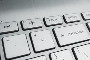 Closeup of Laptop Keyboard with Delete, Backspace, and Airplane Mode Keys photo