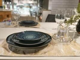Elegant table setting with blue dinnerware and glassware. Preparation for a dinner party with friends or relatives. photo