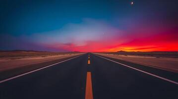 An empty road with a sunset in the background photo
