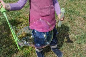 Soap bubble, outdoors activity and leisure for happy kid, real life photo, playing photo