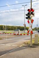 Closing barriers and flashing red traffic lights. ban on entering a railway and road crossing. photo