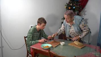 Boy and grandma cutting dough and filling for pies. Cooking at home. Baking for Christmas. Food video