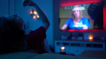 Alone Time at Home. Woman Watching a Film at Night While Snacking on Popcorn and Unwinding on the Sofa video