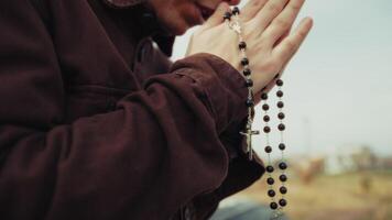Hands Of A Religious Man Praying With A Rosary And Crucifix video