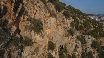 Aerial view. rocky hillside with few trees and ancient caves video