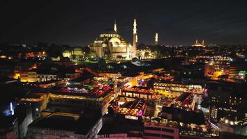 Drone approach and flyover of Suleymaniye Mosque lit up at night video