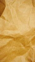 Vintage sepia toned crumpled paper texture background. Stop motion animation of old brown paper with creases and damage. Abstract grunge paper texture. Full HD and looping vertical animation. video