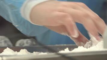 A childs hand rolls a ball of flour video