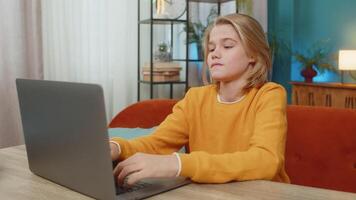 Teenager boy frustrated playing difficult game on laptop, banging keyboard on couch at home video