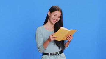 Happy Caucasian woman reading funny interesting fairytale story book, leisure hobby, learning, study video