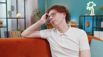 Thoughtful man sitting at home looks pensive thinks of unrequited love depressed bad feeling burnout video