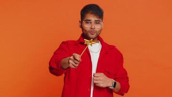 Magician wizard young man gesturing with magic wand making wish come true, casting magician spell video